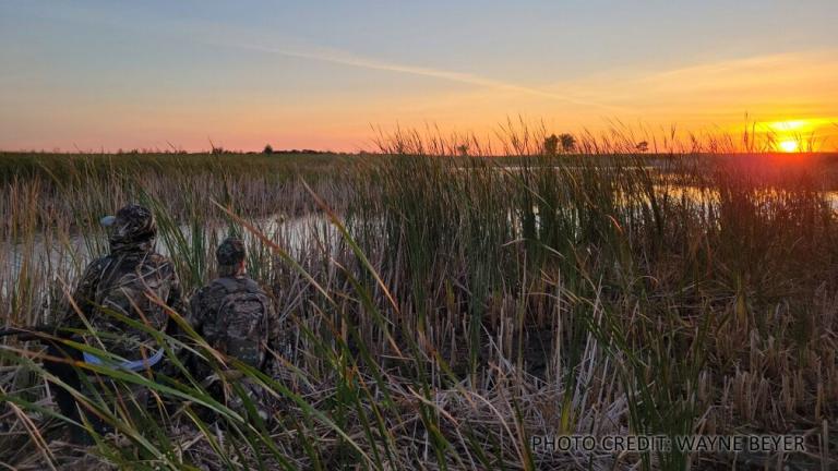 Young hunters duck hunting at sunrise